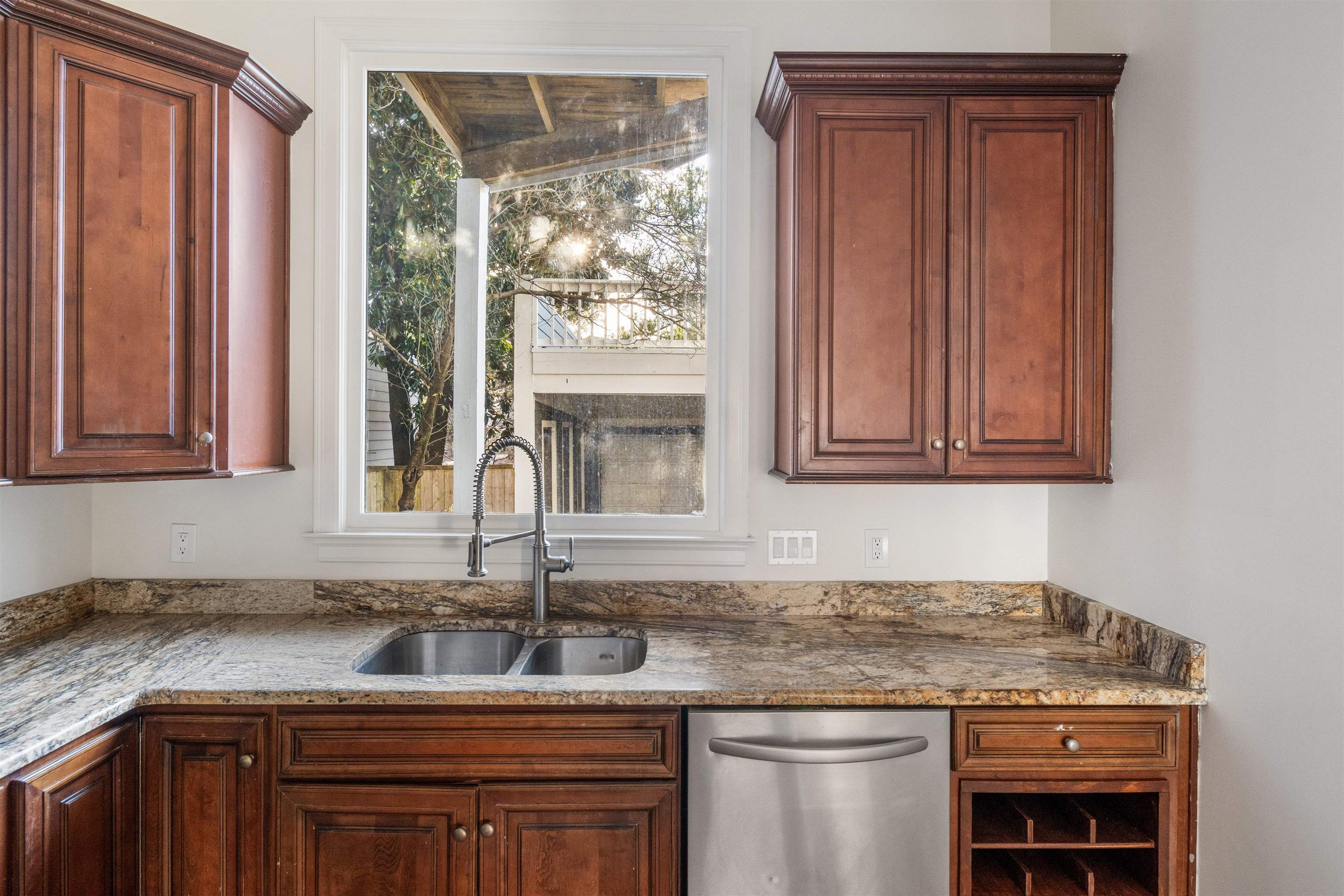 931 Harbor View Drive Memphis, TN 38103 - Photo 10 of 21 a kitchen with stainless steel appliances granite countertop a sink and a wooden cabinets