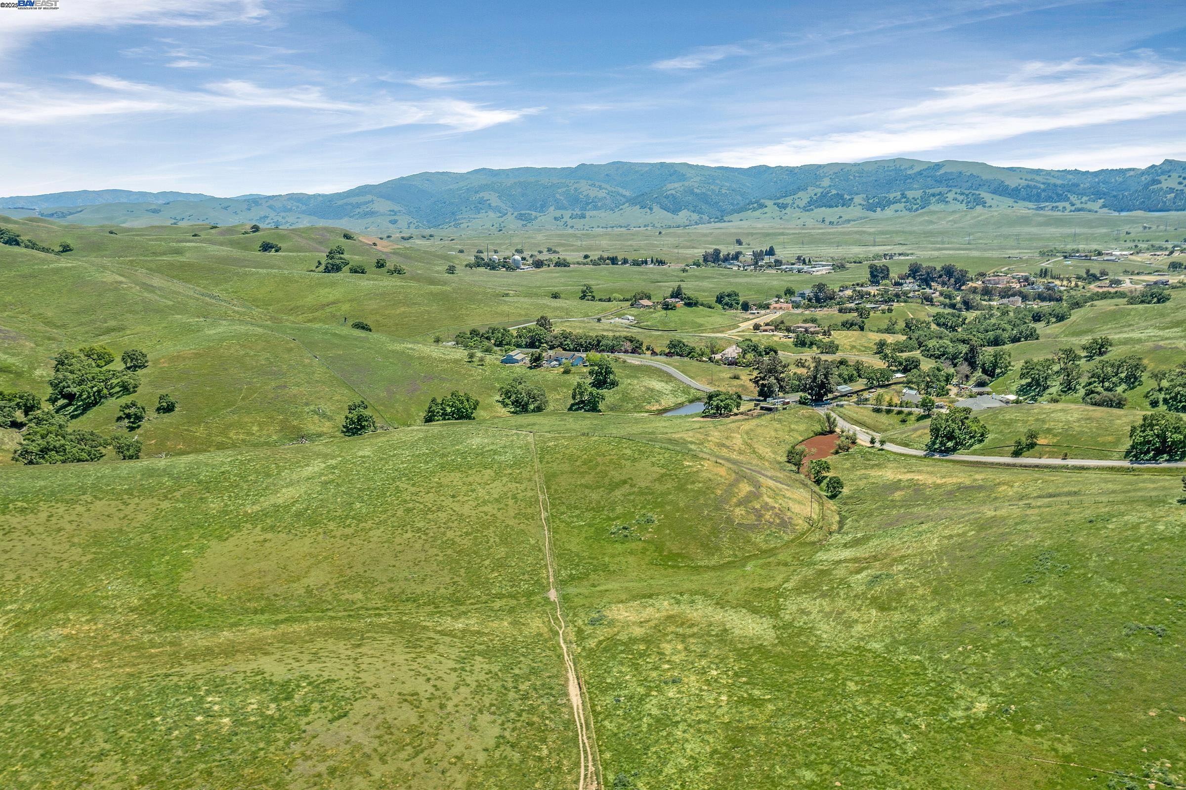 3343 Little Valley Road Sunol, CA 94586 - Photo 8 of 23 a view of a lush green hillside and houses