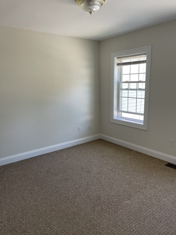 26 Main Street, Unit REAR Framingham, MA 01702 - Photo 4 of 11 an empty room with a window