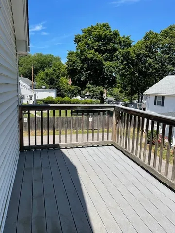 a view of balcony with wooden floor and fence