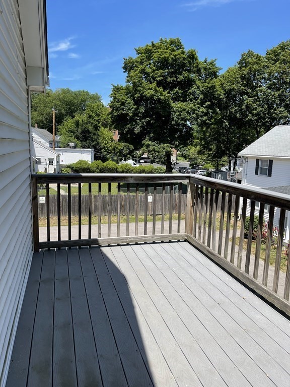 26 Main Street, Unit REAR Framingham, MA 01702 - Photo 6 of 11 a view of balcony with wooden floor and fence