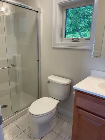 a bathroom with a toilet and a shower