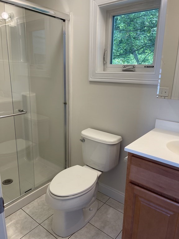 26 Main Street, Unit REAR Framingham, MA 01702 - Photo 7 of 11 a bathroom with a toilet and a shower