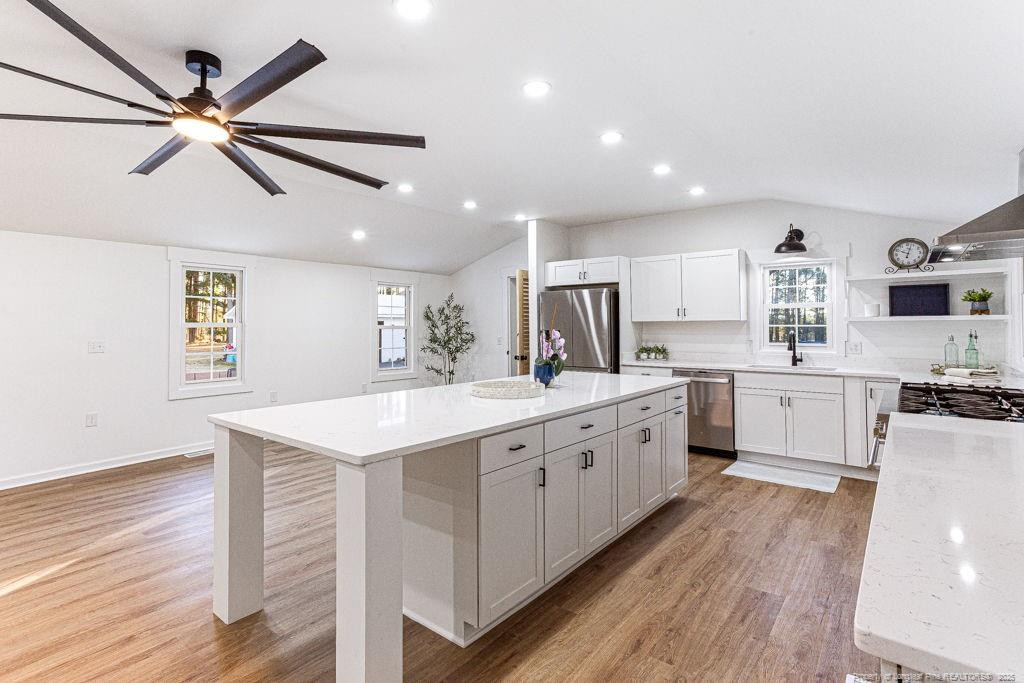 447 T T Johnson Road Carthage, NC 28327 - Photo 13 of 49 a large kitchen with stainless steel appliances granite countertop a lot of counter space and wooden floors