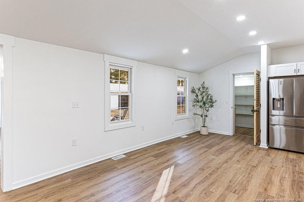 447 T T Johnson Road Carthage, NC 28327 - Photo 14 of 49 a view of a big room with wooden floor and a kitchen