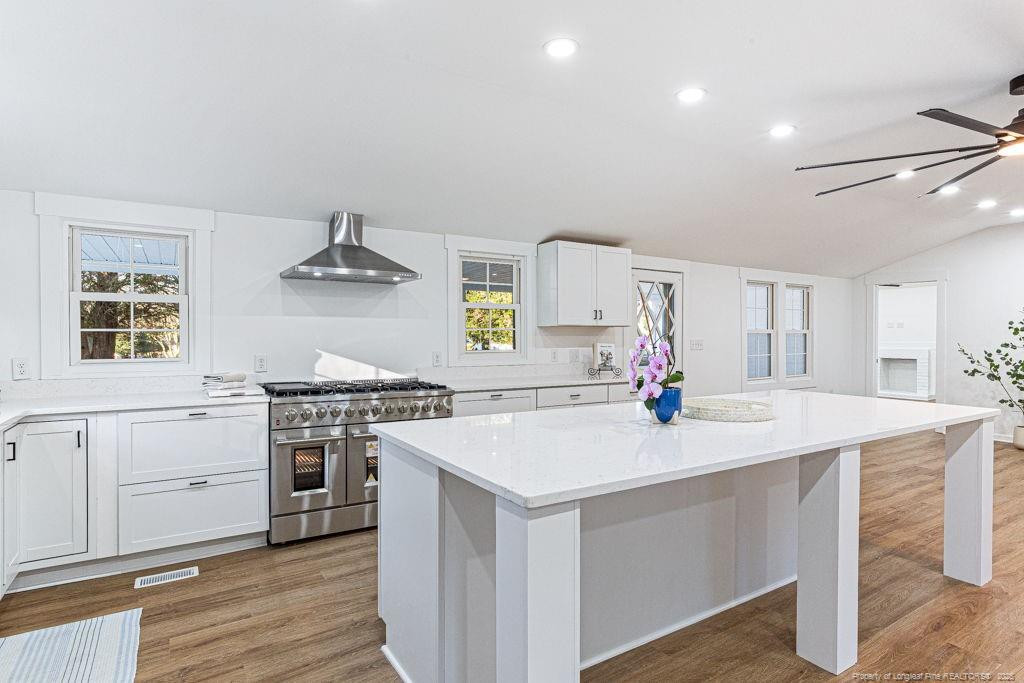 447 T T Johnson Road Carthage, NC 28327 - Photo 18 of 49 a kitchen with a stove a sink and a refrigerator