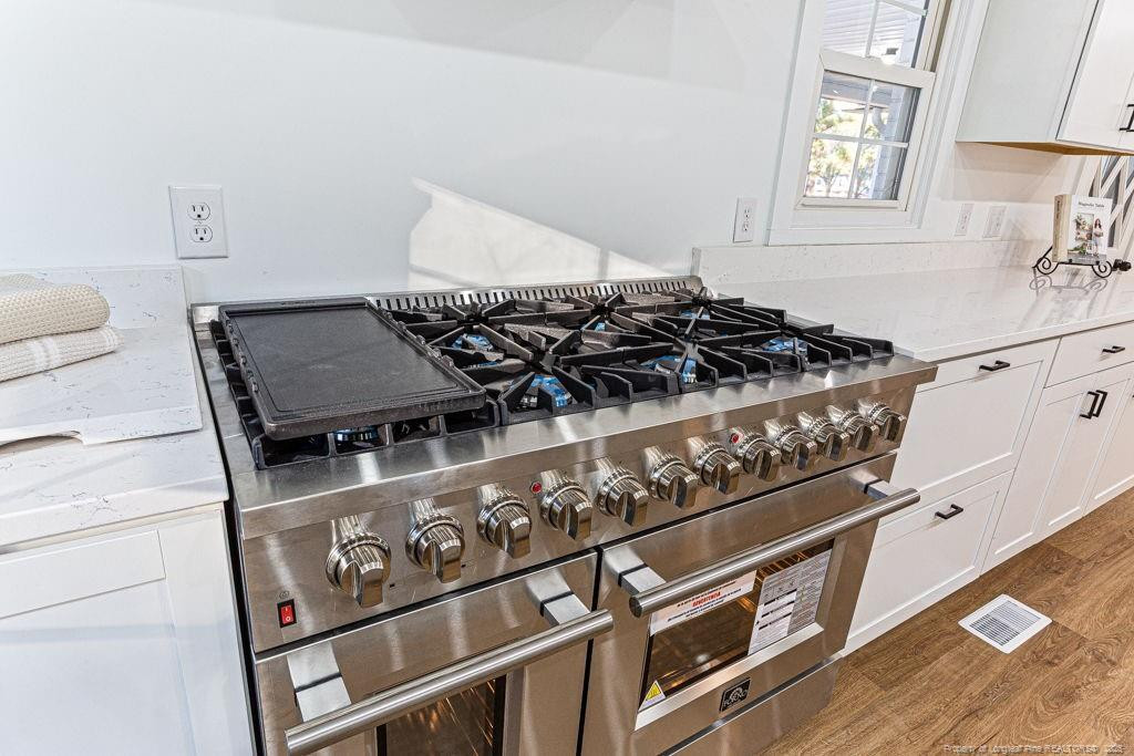 447 T T Johnson Road Carthage, NC 28327 - Photo 21 of 49 a close view of a stove a sink and dishwasher with wooden floor