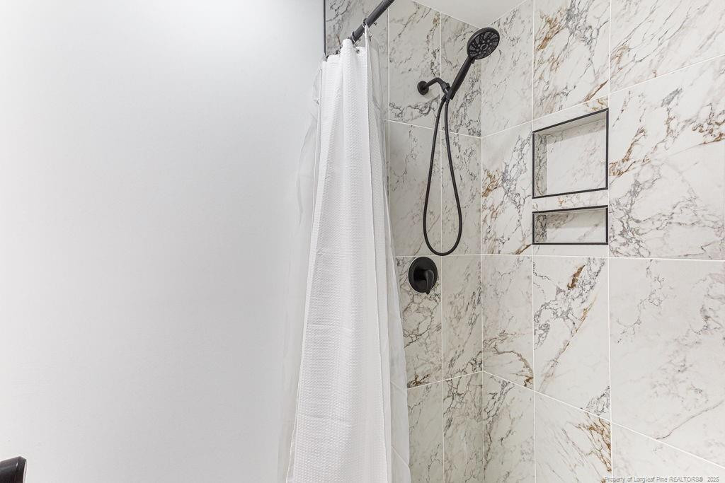 447 T T Johnson Road Carthage, NC 28327 - Photo 28 of 49 a bathroom with a glass shower door