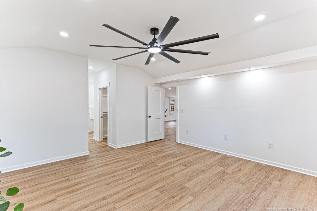 447 T T Johnson Road Carthage, NC 28327 - Photo 31 of 49 an empty room with wooden floor and windows