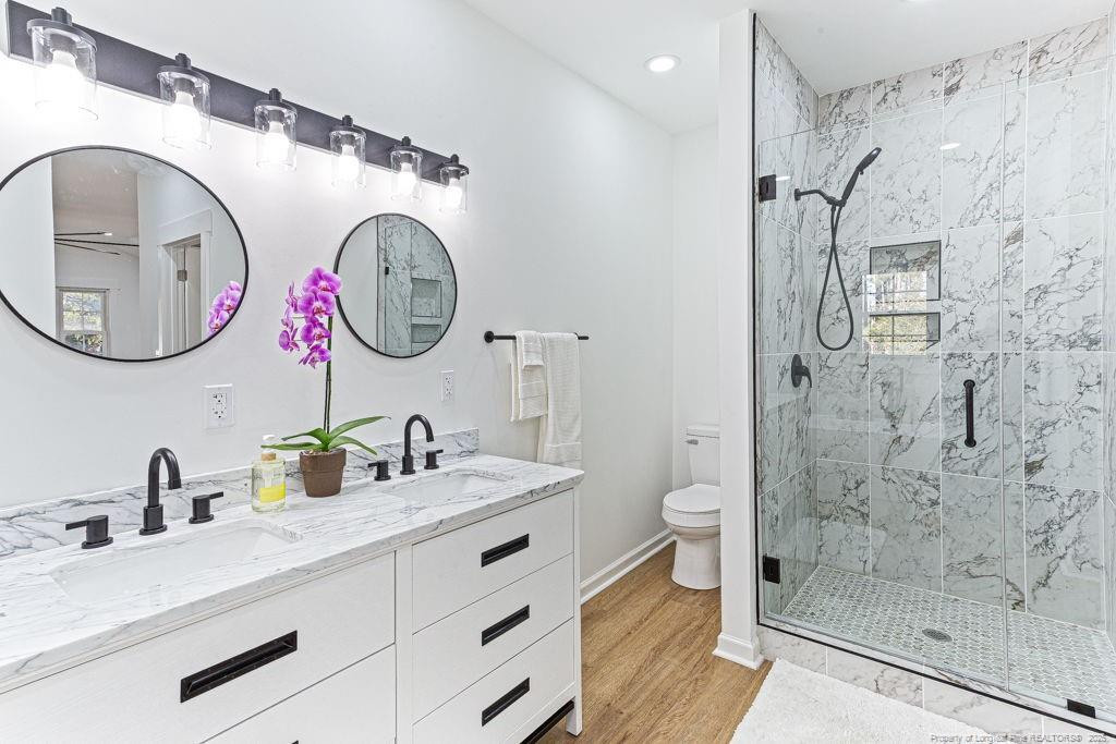 447 T T Johnson Road Carthage, NC 28327 - Photo 35 of 49 a bathroom with a granite countertop sink mirror vanity and toilet