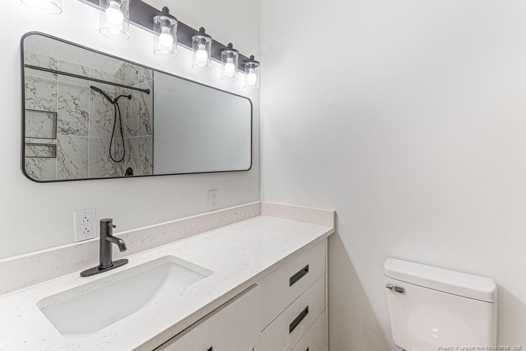 447 T T Johnson Road Carthage, NC 28327 - Photo 41 of 49 a bathroom with a sink and a mirror