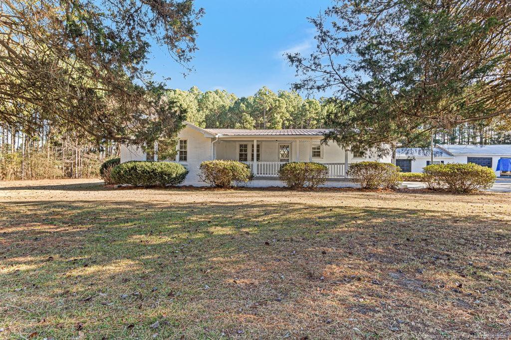 447 T T Johnson Road Carthage, NC 28327 - Photo 7 of 49 a front view of a house with garden
