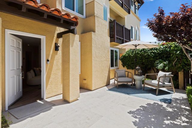 a view of a patio with a table and chairs