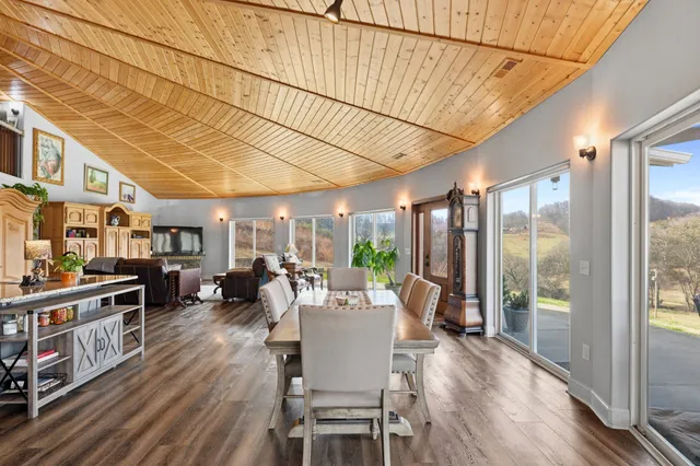 a kitchen with stainless steel appliances granite countertop a kitchen island hardwood floor and a sink