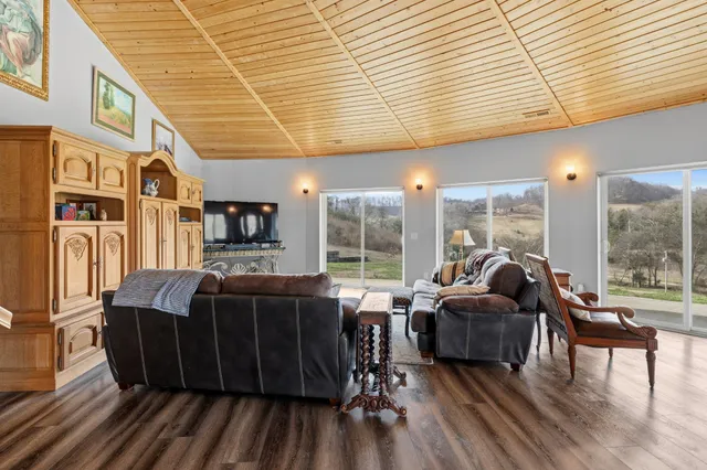 a view of a dining room with furniture large windows and wooden floor