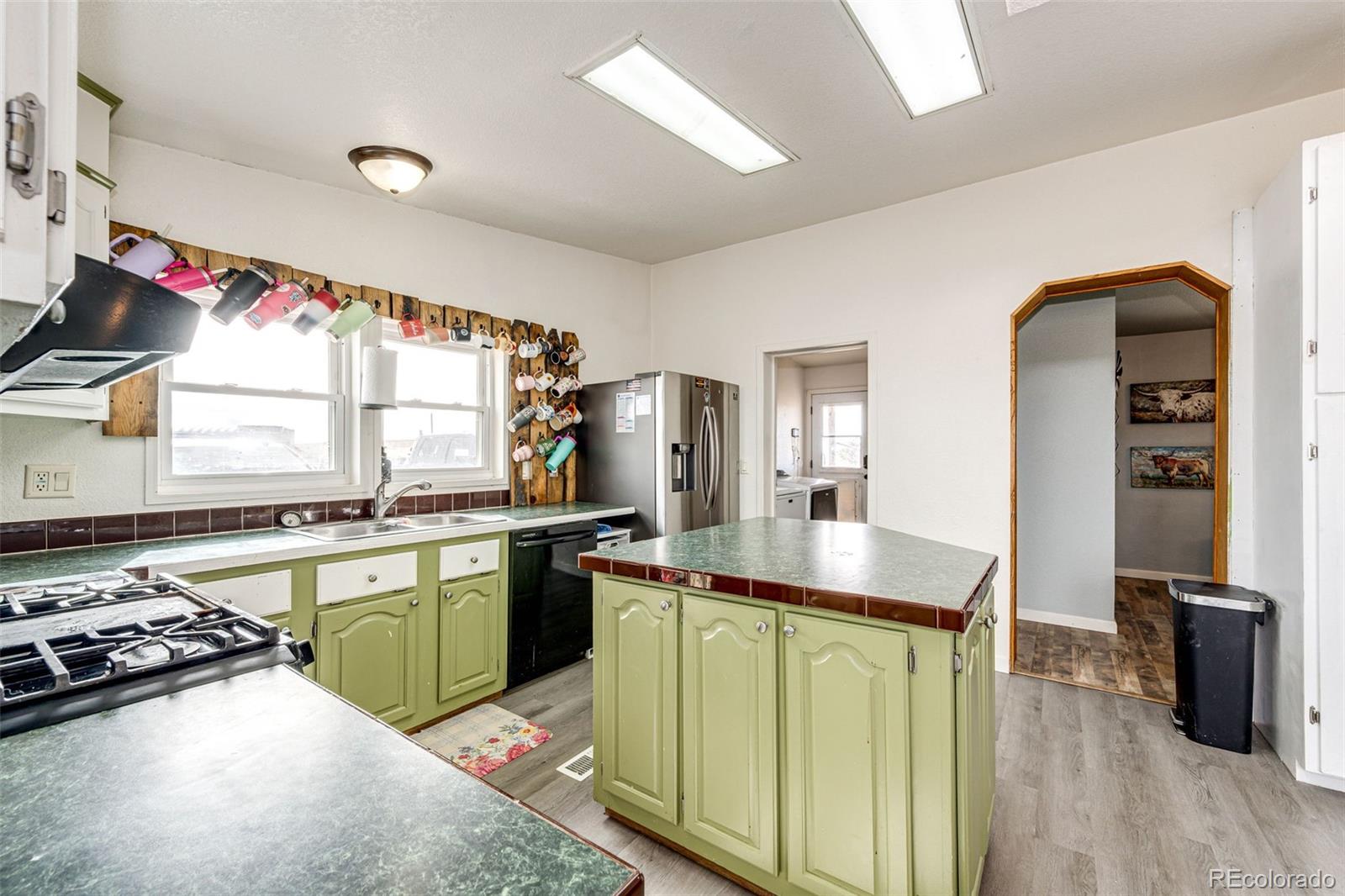 26101 Flower Circle Simla, CO 80835 - Photo 12 of 48 a kitchen with stainless steel appliances granite countertop a sink stove and refrigerator