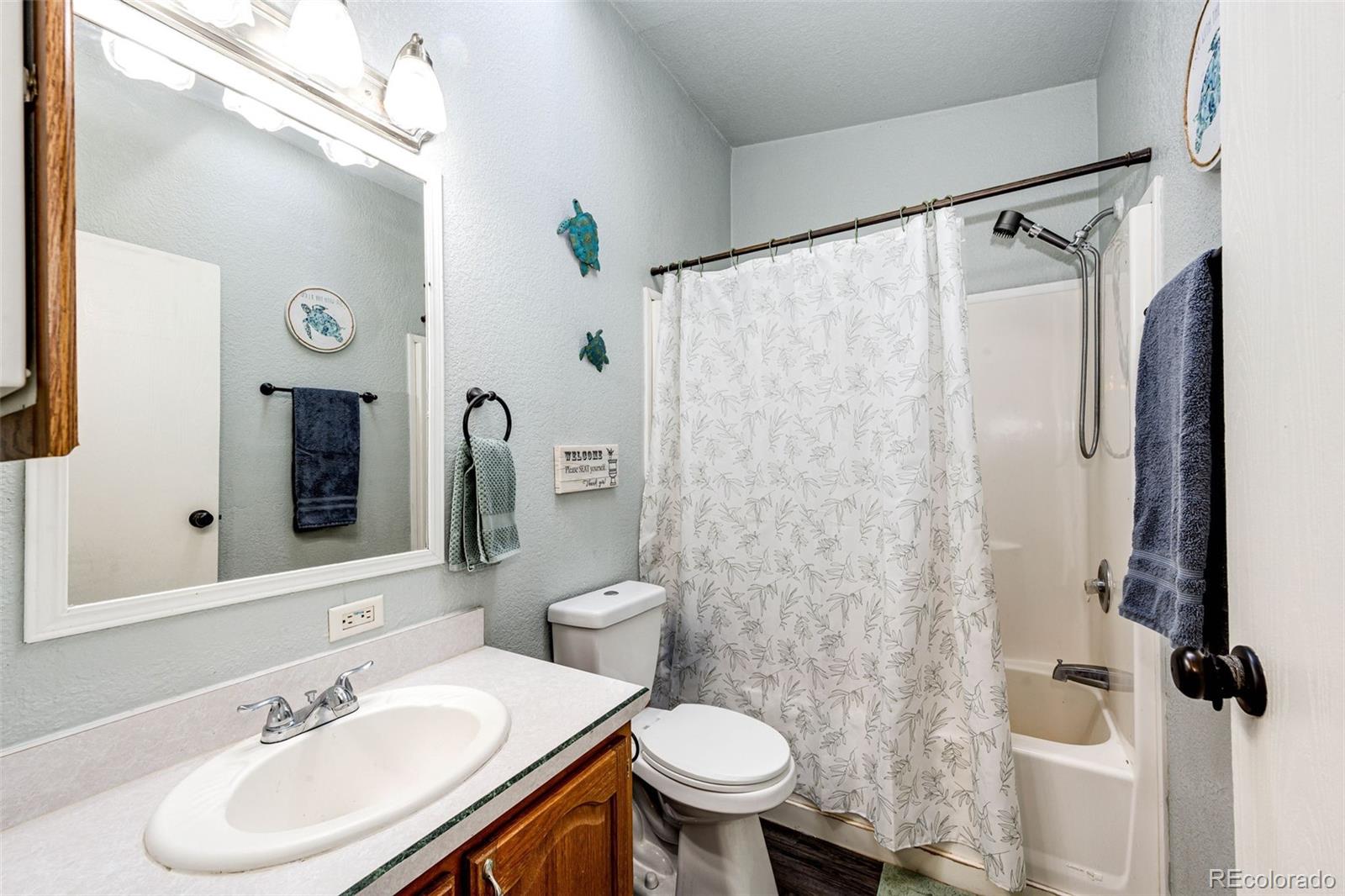 26101 Flower Circle Simla, CO 80835 - Photo 15 of 48 a bathroom with a sink toilet and shower