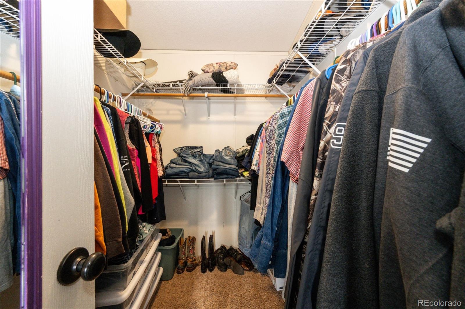 26101 Flower Circle Simla, CO 80835 - Photo 20 of 48 a view of walk in closet with clothes and shoes