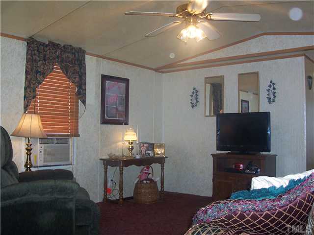 292 Christys Way Roxboro, NC 27574 - Photo 6 of 23 a living room with furniture and a flat screen tv