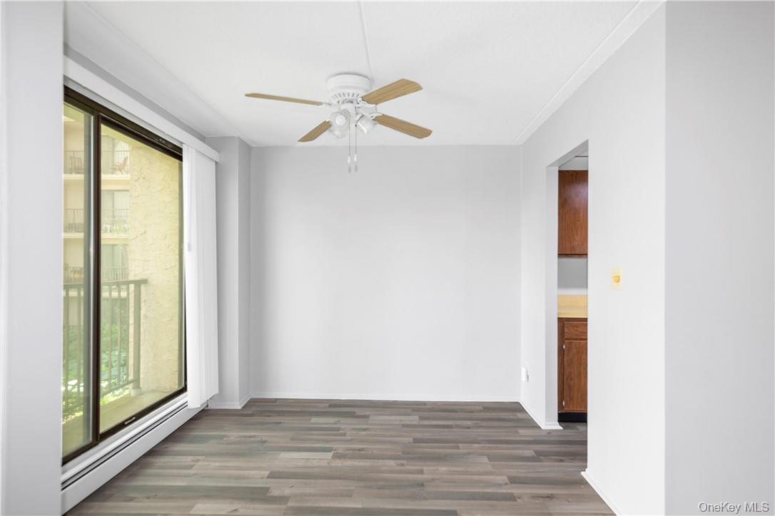 150 Overlook Avenue, Unit 2K Peekskill, NY 10566 - Photo 2 of 26 a view of an empty room with wooden floor and a window