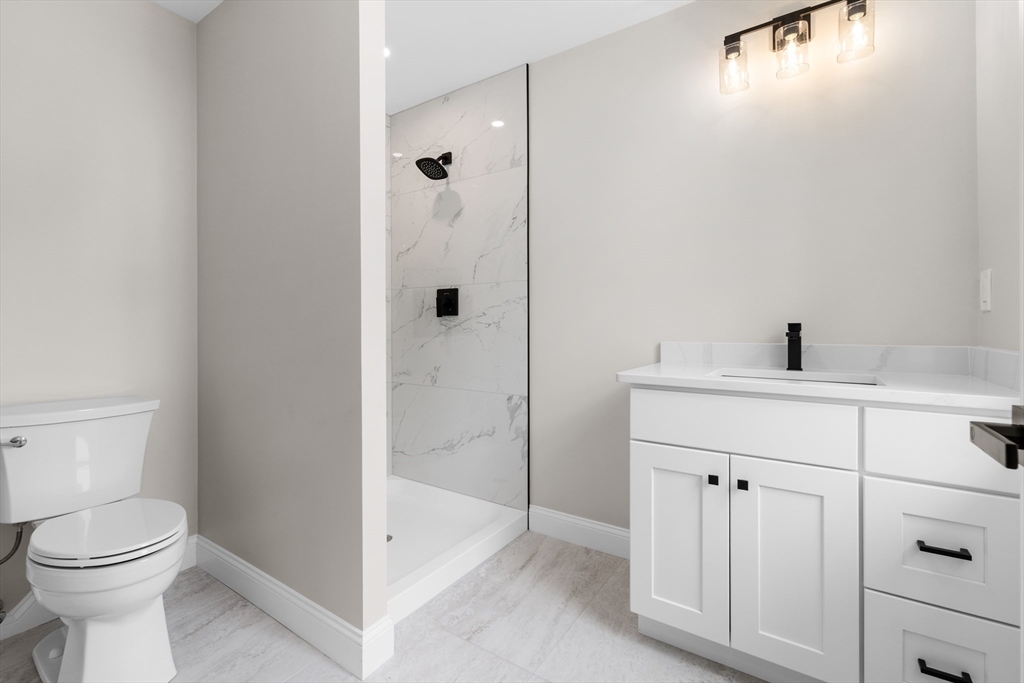 122 Stowe Street, Unit 122 Fall River, MA 02720 - Photo 19 of 26 a bathroom with a sink a toilet and shower