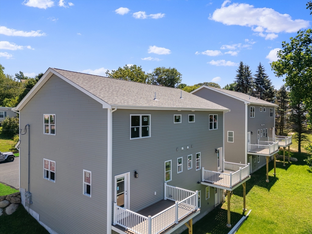 122 Stowe Street, Unit 122 Fall River, MA 02720 - Photo 3 of 26 a aerial view of a house with a yard
