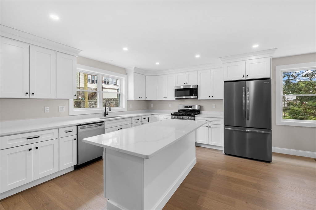 122 Stowe Street, Unit 122 Fall River, MA 02720 - Photo 5 of 26 a kitchen with white cabinets and stainless steel appliances