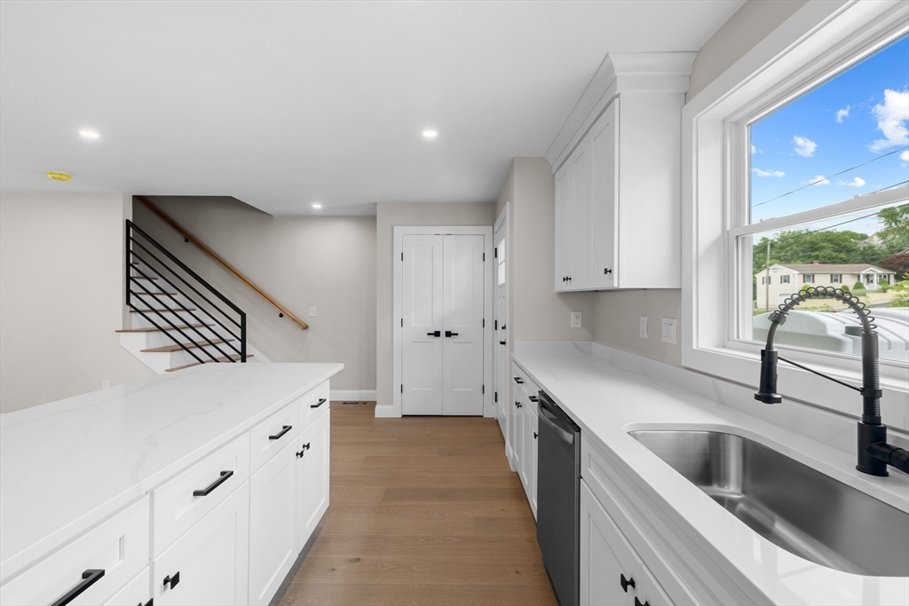 122 Stowe Street, Unit 122 Fall River, MA 02720 - Photo 8 of 26 a kitchen with granite countertop a sink and cabinets