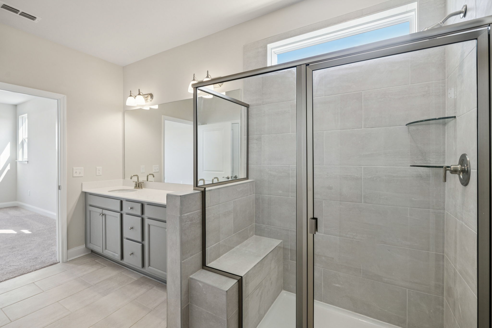 8140 Rocky Fork Almaville Road Smyrna, TN 37167 - Photo 14 of 43 a bathroom with a double vanity sink a mirror and a shower