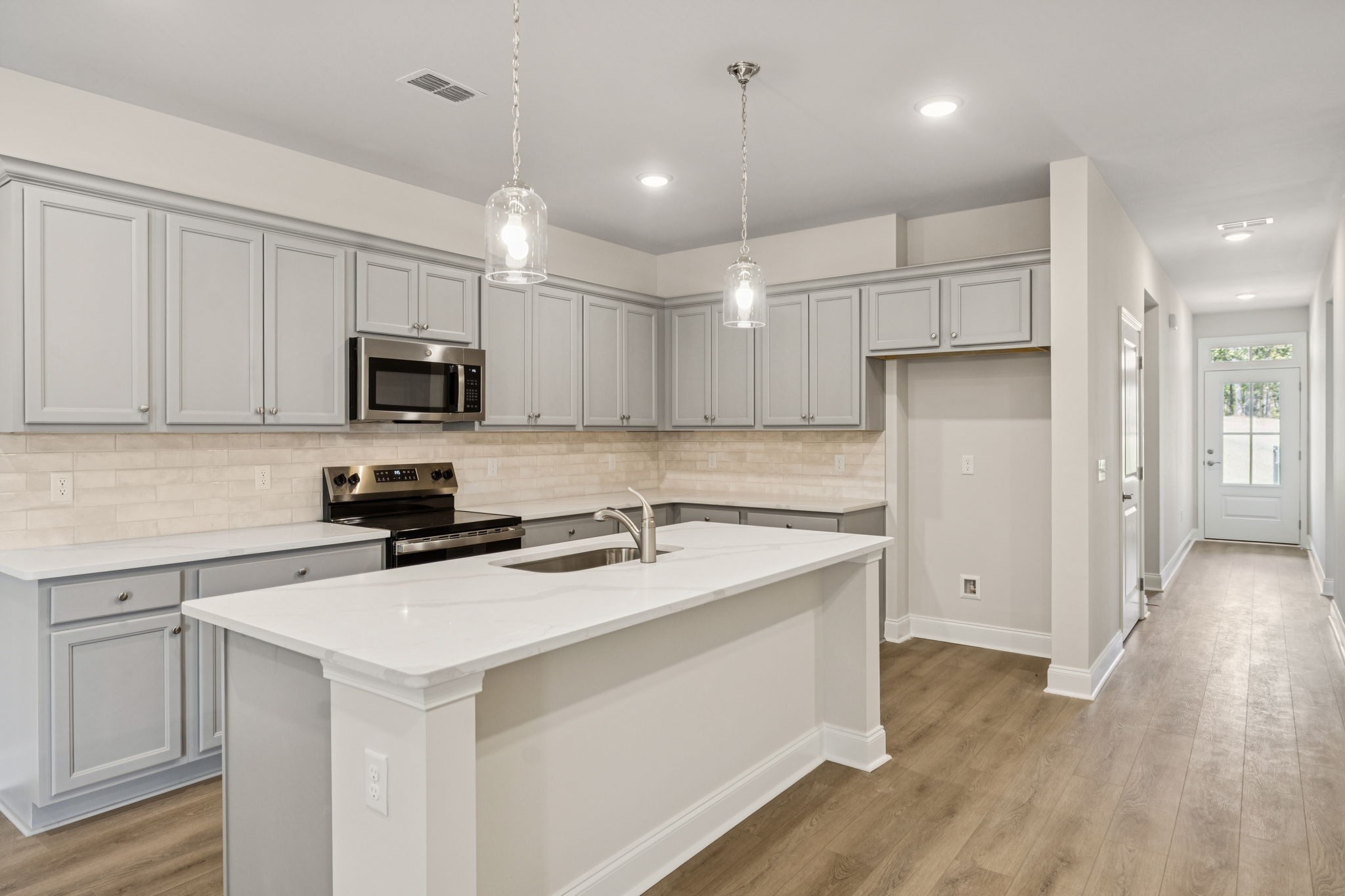 8140 Rocky Fork Almaville Road Smyrna, TN 37167 - Photo 22 of 43 a kitchen with a sink a stove a refrigerator a center island and cabinets