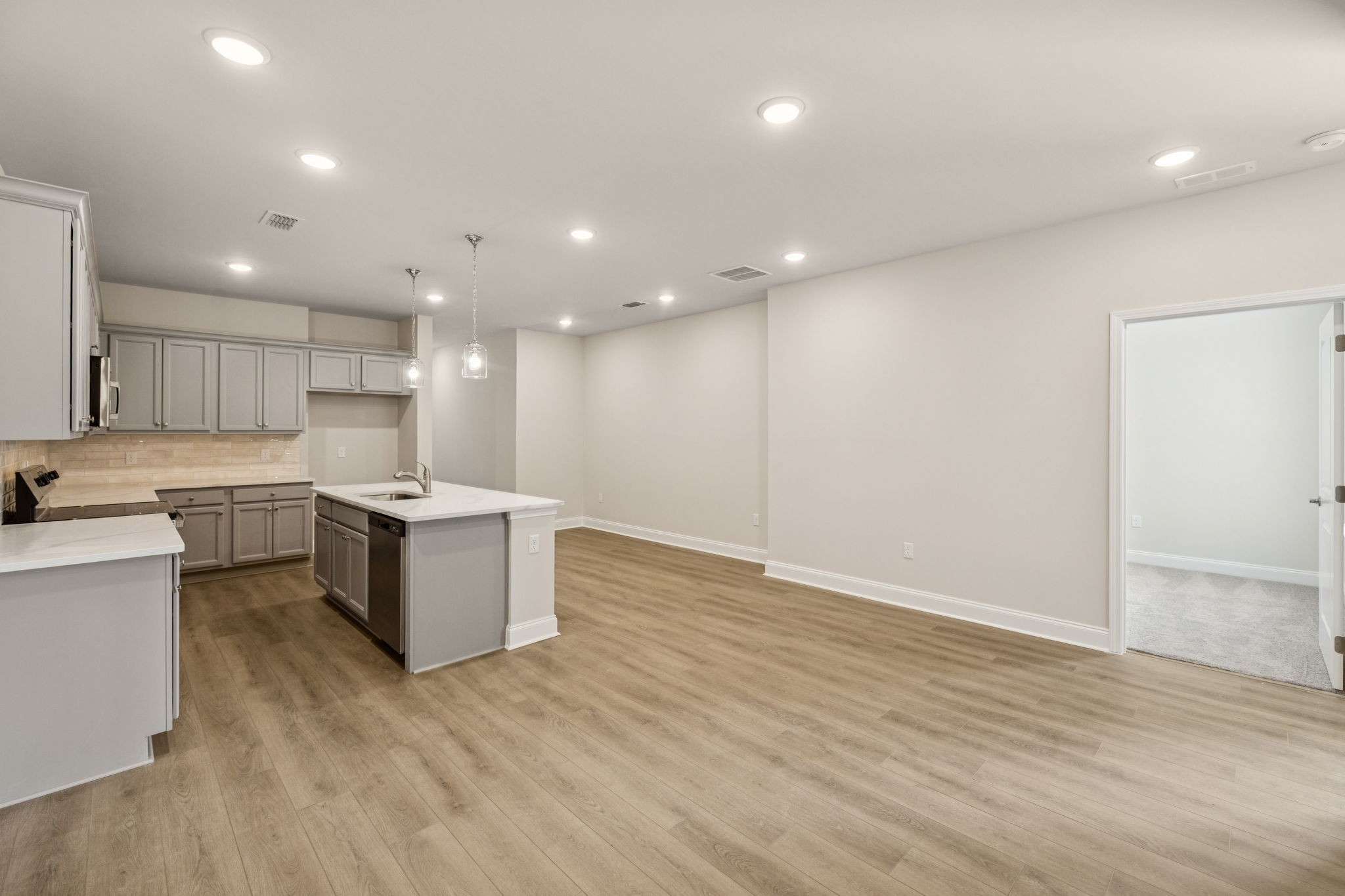 8140 Rocky Fork Almaville Road Smyrna, TN 37167 - Photo 26 of 43 a large white kitchen with a sink and dishwasher a refrigerator with wooden floor
