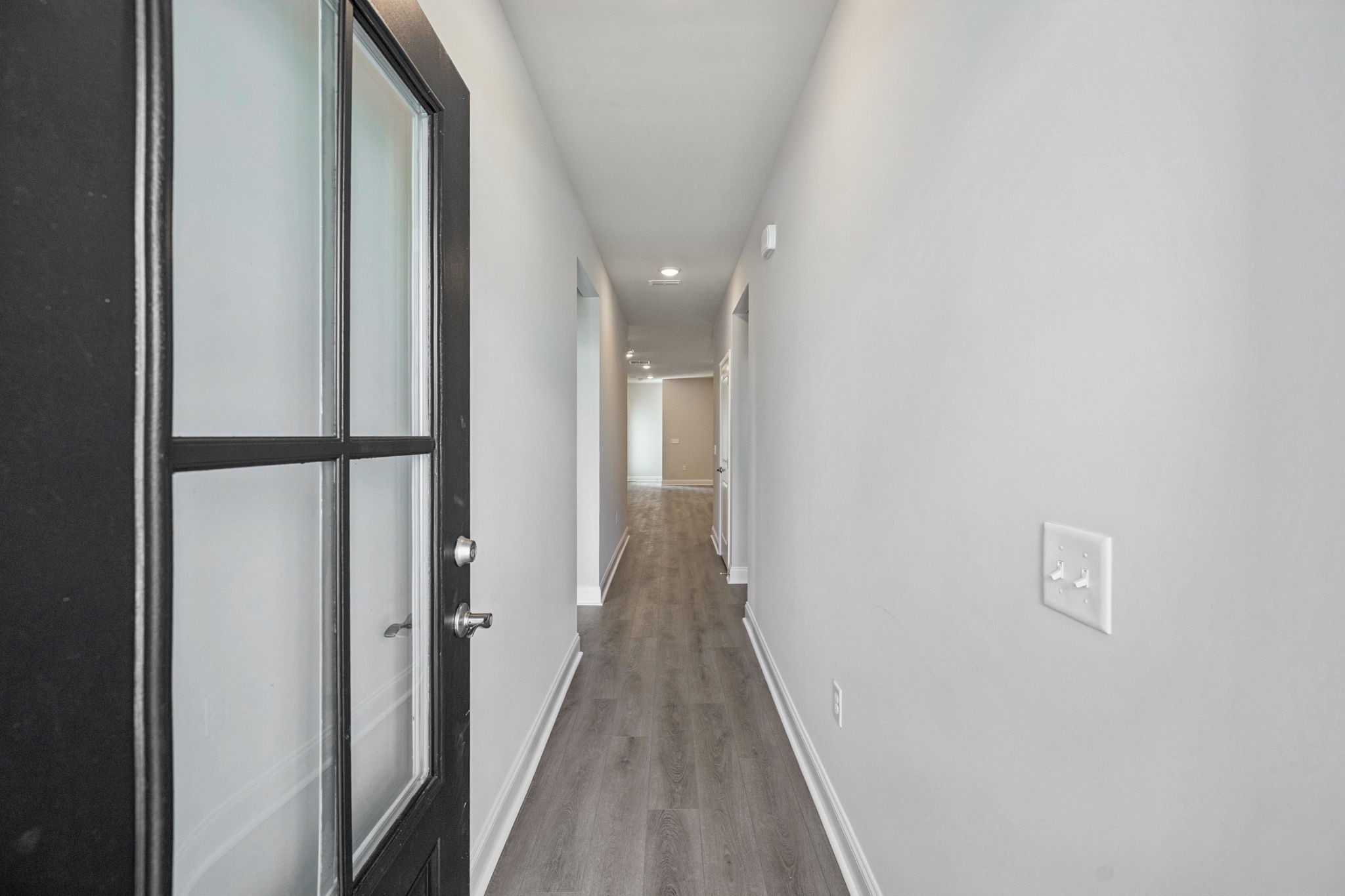 8140 Rocky Fork Almaville Road Smyrna, TN 37167 - Photo 6 of 43 a view of a hallway with wooden floor and a bathroom