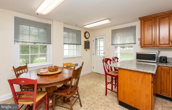a dining room with furniture and window