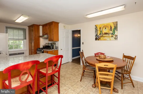 a dining room with furniture and a large window