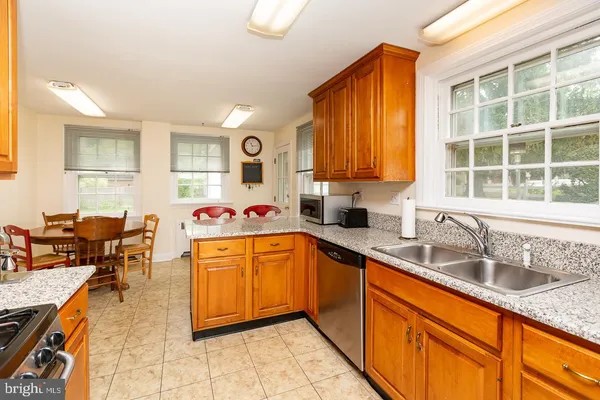 a kitchen with stainless steel appliances granite countertop sink stove and cabinets