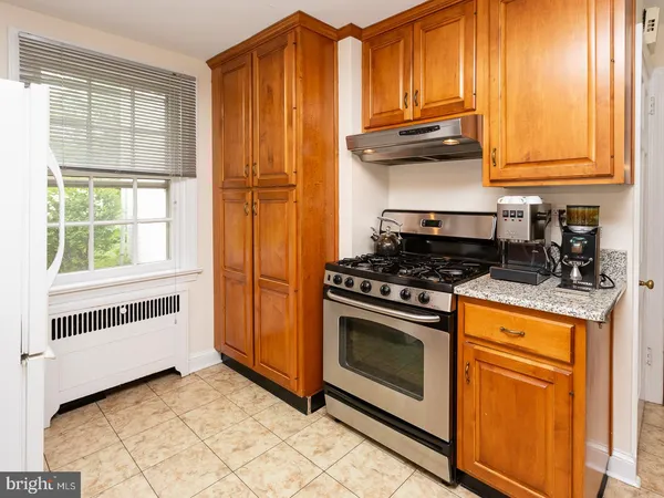 a kitchen with granite countertop cabinets stainless steel appliances and a window
