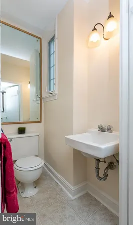 a bathroom with a sink toilet and mirror