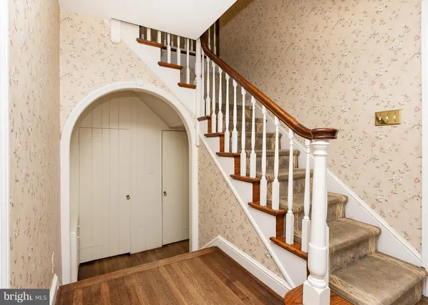 a view of staircase with railing and white walls