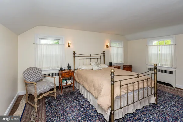 a bed room with a bed and chair