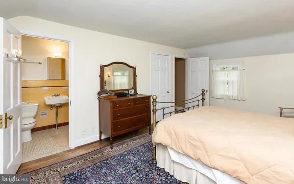 a spacious bedroom with a bed and a view of bathroom