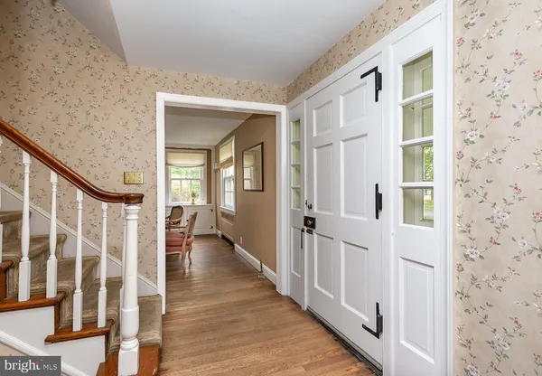 a view of a hallway with wooden floor and windows