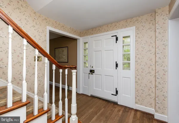 a view of an entryway with wooden floor