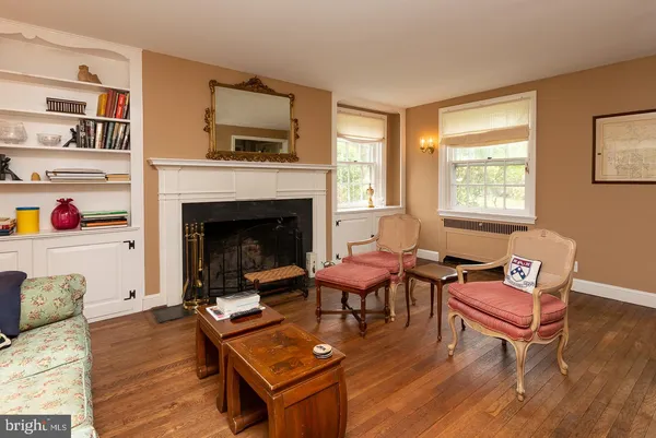 a living room with furniture fireplace and window