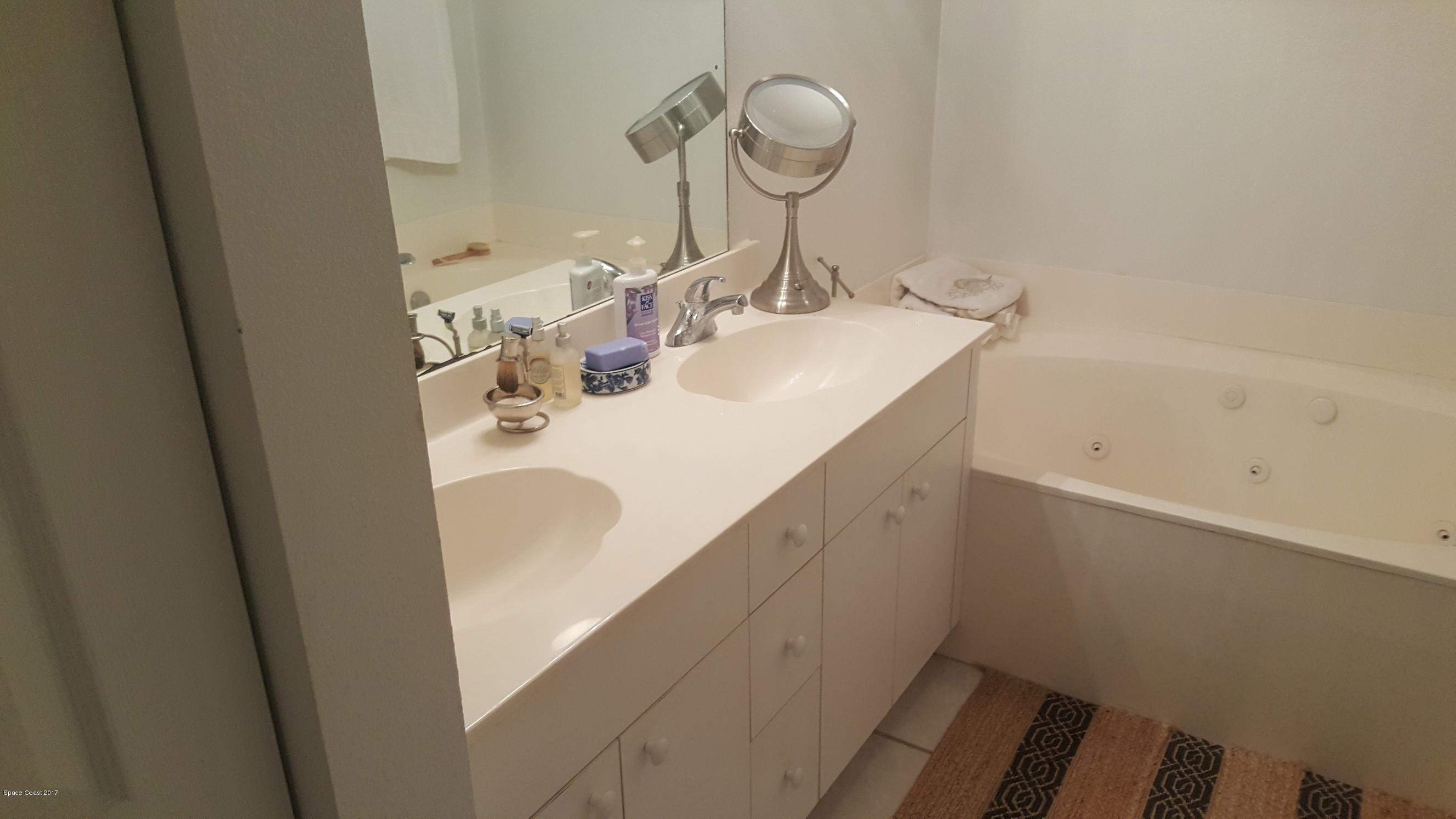 100 Riverside Drive, Unit 804 Cocoa, FL 32922 - Photo 11 of 11 a bathroom with a sink and a mirror