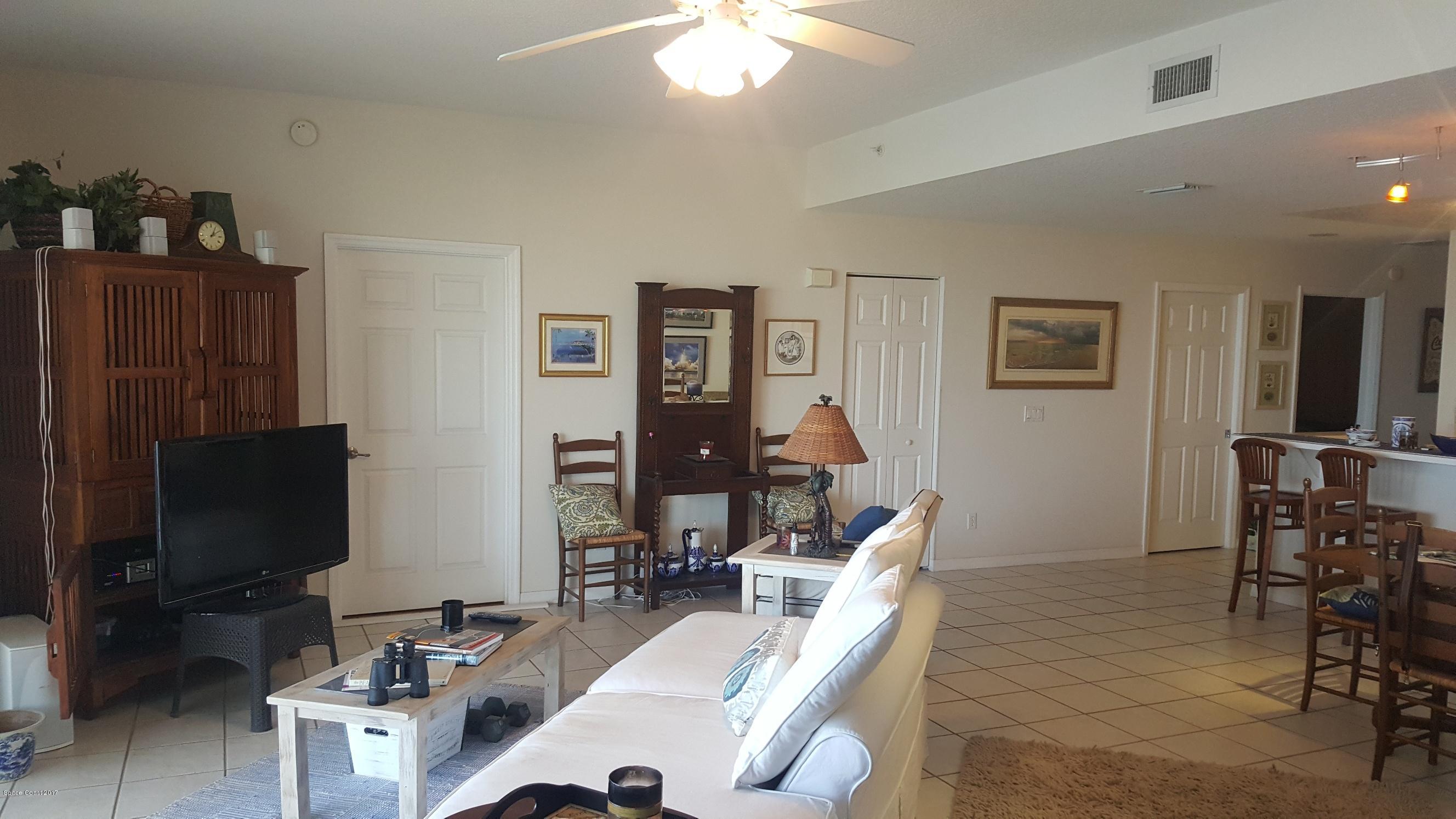 100 Riverside Drive, Unit 804 Cocoa, FL 32922 - Photo 5 of 11 a room with furniture a flat screen tv and gym equipment