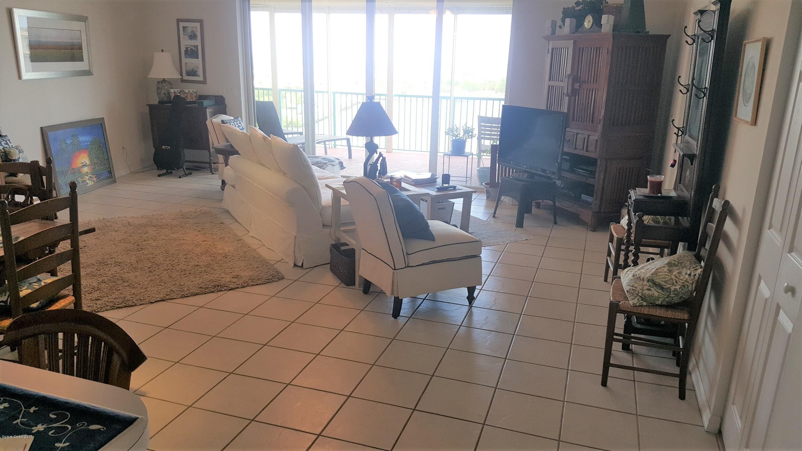 100 Riverside Drive, Unit 804 Cocoa, FL 32922 - Photo 8 of 11 a living room with furniture and a floor to ceiling window