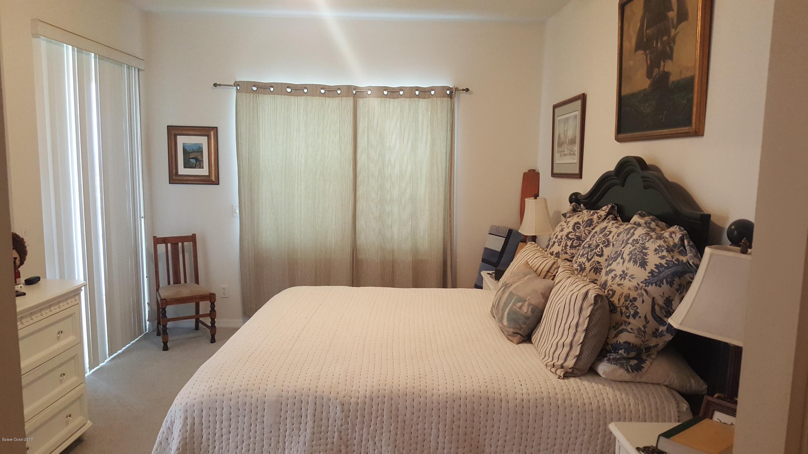 100 Riverside Drive, Unit 804 Cocoa, FL 32922 - Photo 9 of 11 a bedroom with a bed and a window