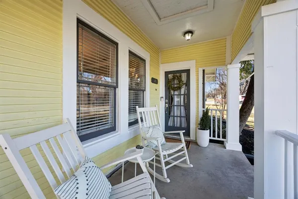 a balcony view with a seating space