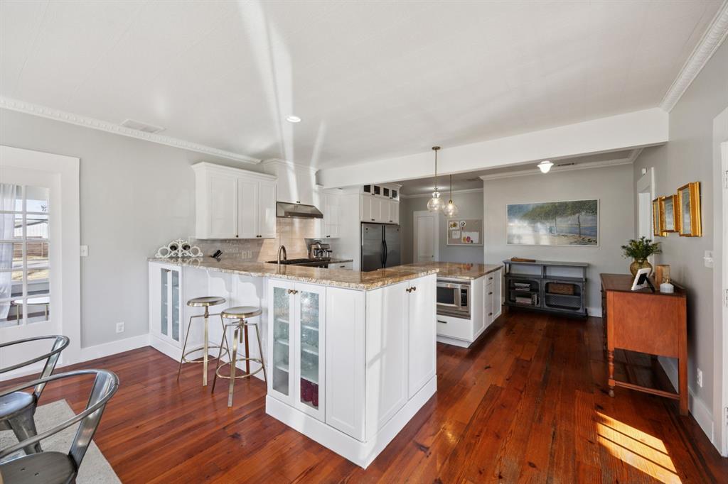704 Williams Street Rockwall, TX 75087 - Photo 15 of 39 a kitchen with stainless steel appliances a stove top oven a refrigerator a dining table and chairs