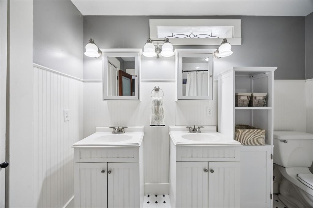 704 Williams Street Rockwall, TX 75087 - Photo 21 of 39 a bathroom with a sink vanity and a mirror